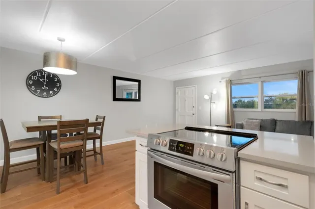 a kitchen with a table chairs and a stove