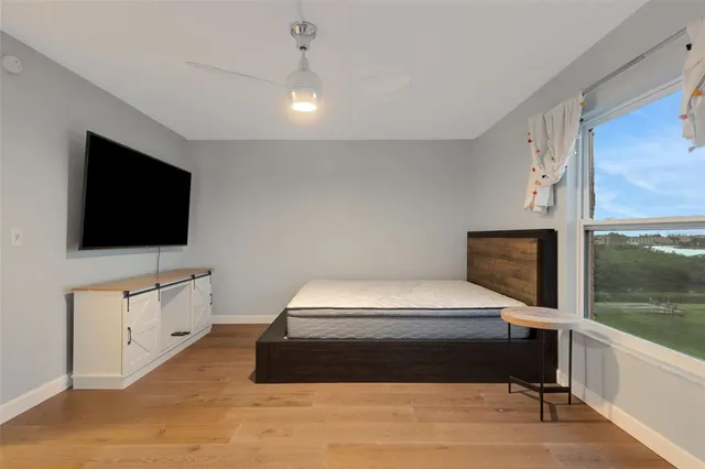 a bedroom with a bed and a flat screen tv