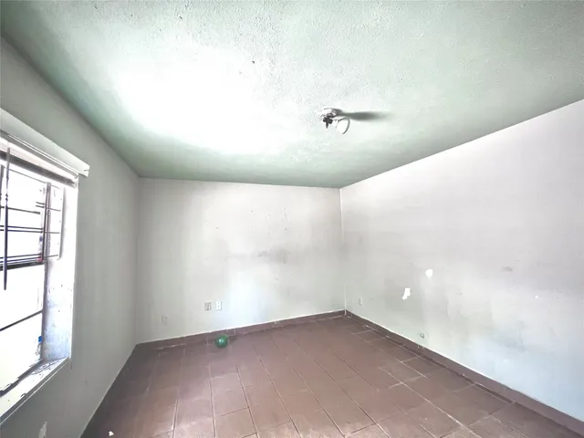 a view of an empty room and window