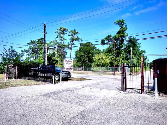 a view of backyard with a table and chairs and potted plants