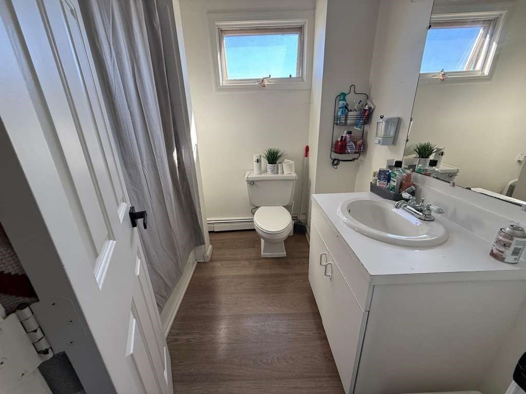 642-648 Eastern Avenue, Unit 3 Lynn, MA 01902 - Photo 6 of 7 a bathroom with a sink and mirror with toilet