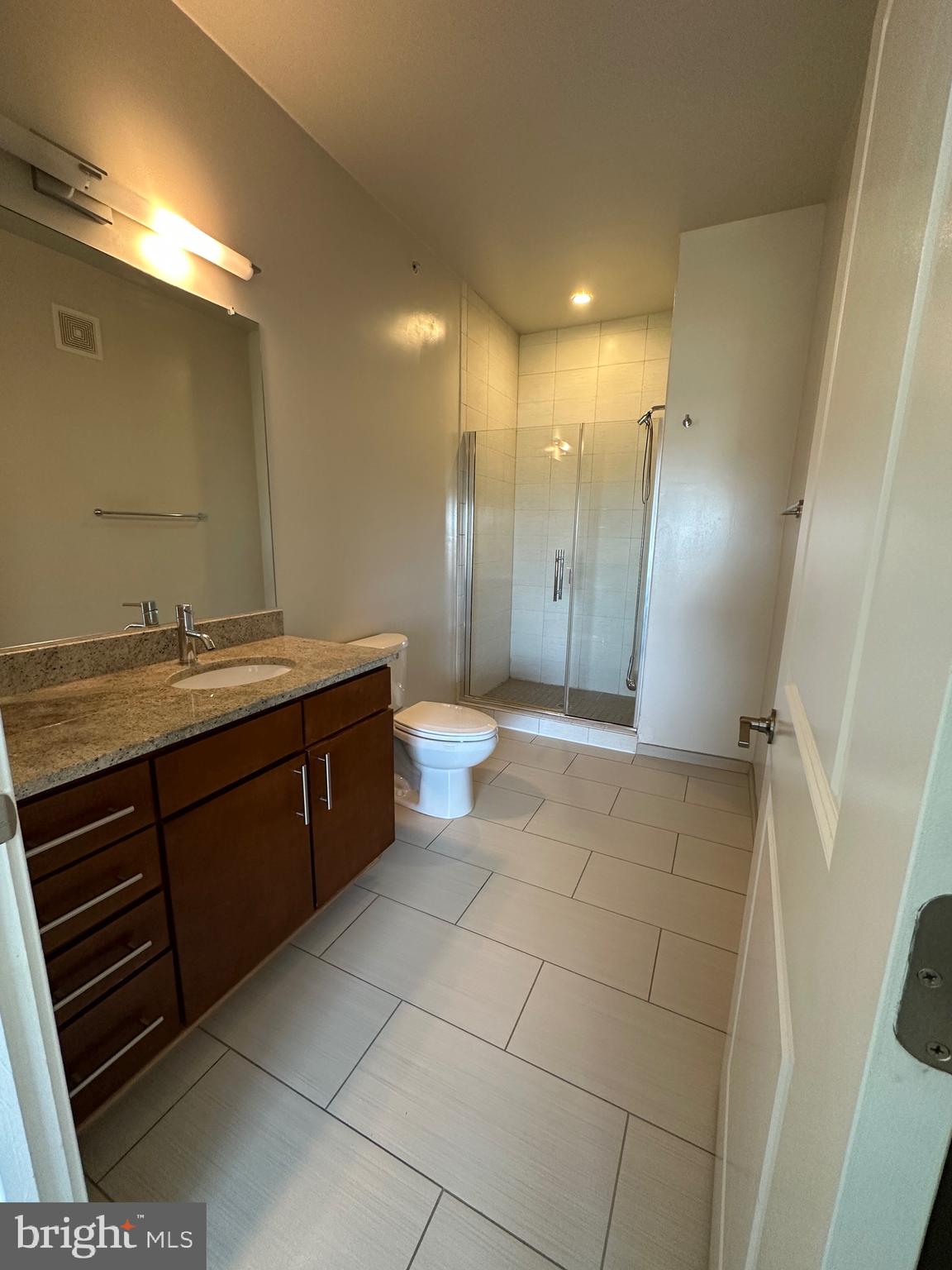 8005 13th Street, Unit 408 Silver Spring, MD 20910 - Photo 12 of 24 a bathroom with a double vanity sink a mirror and a shower