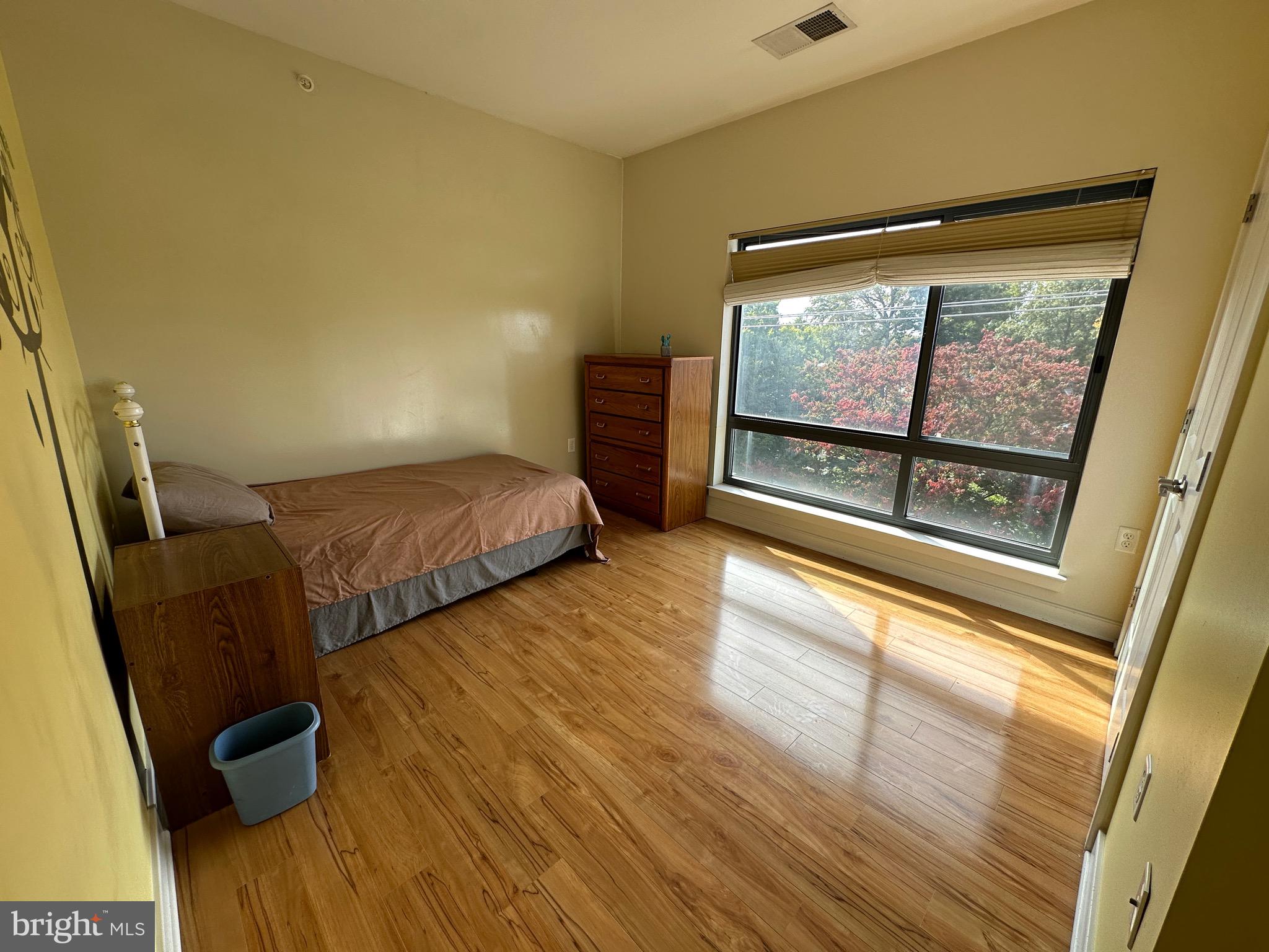 8005 13th Street, Unit 408 Silver Spring, MD 20910 - Photo 13 of 24 a bedroom with two beds and a large window