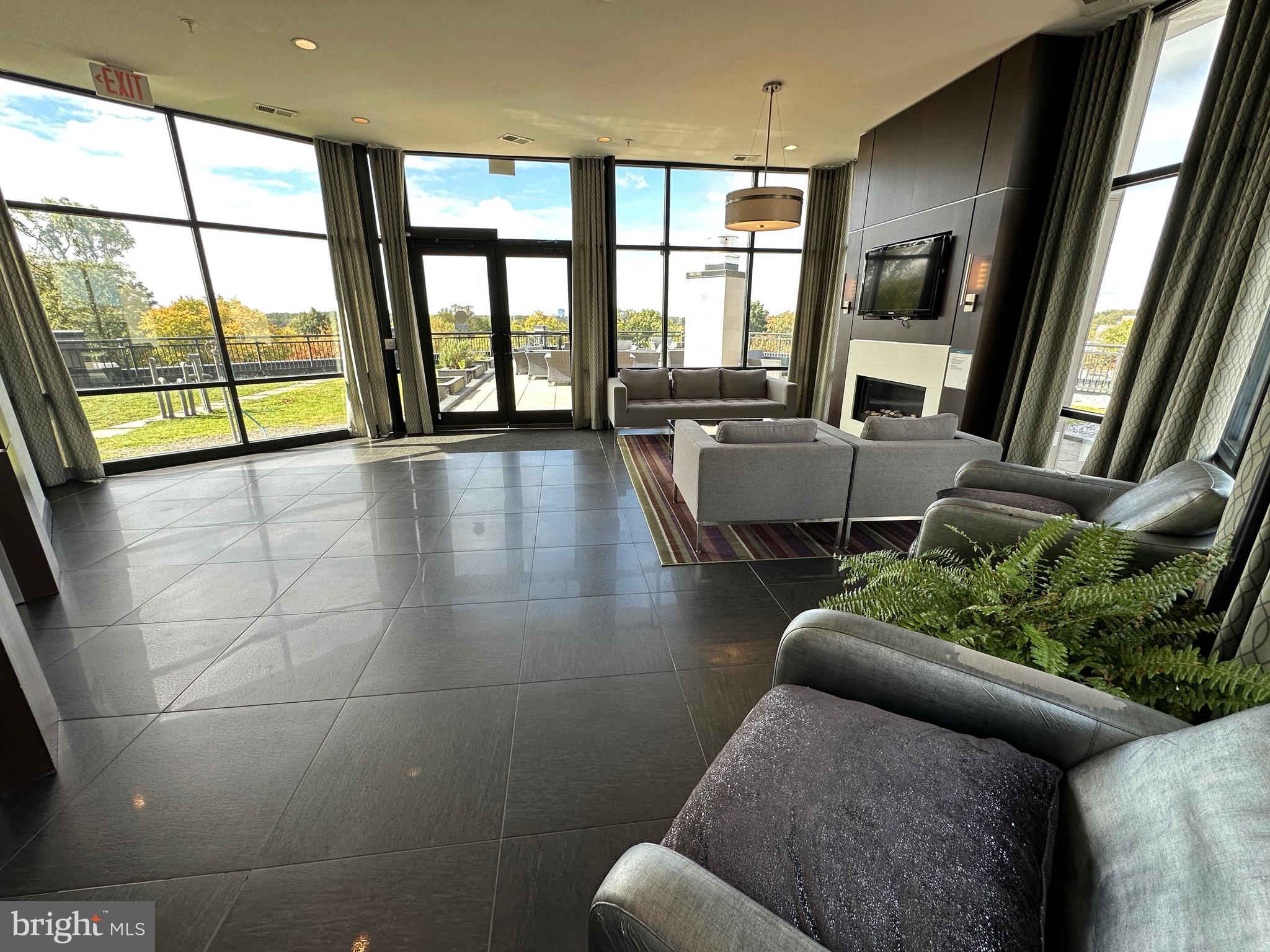 8005 13th Street, Unit 408 Silver Spring, MD 20910 - Photo 16 of 24 a living room with furniture and a large window