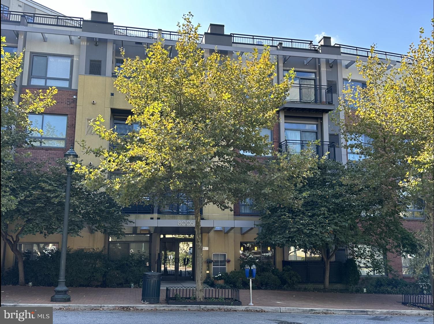 8005 13th Street, Unit 408 Silver Spring, MD 20910 - Photo 2 of 24 a yellow building with trees in front of it