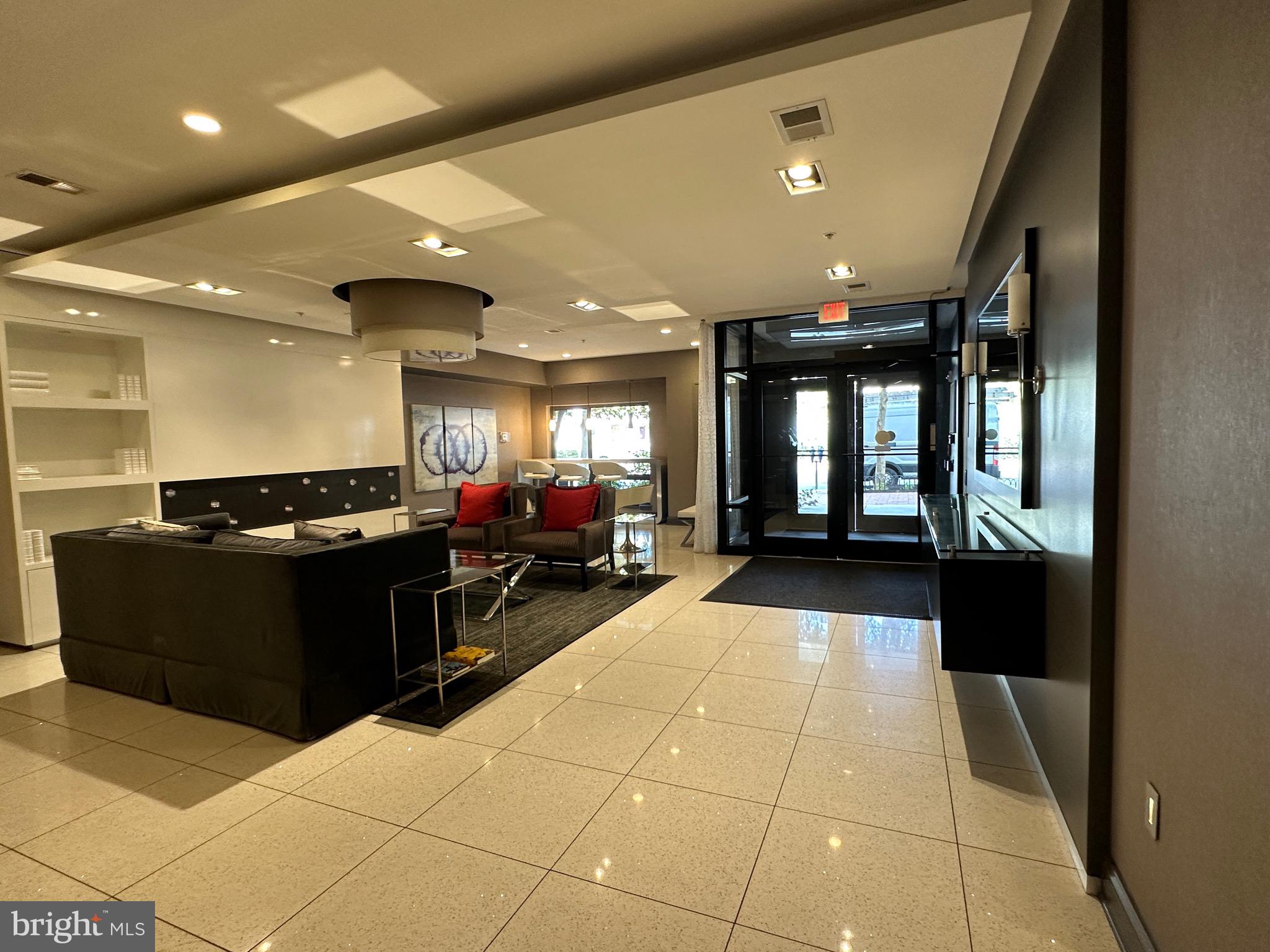 8005 13th Street, Unit 408 Silver Spring, MD 20910 - Photo 21 of 24 a lobby with furniture and a potted plant