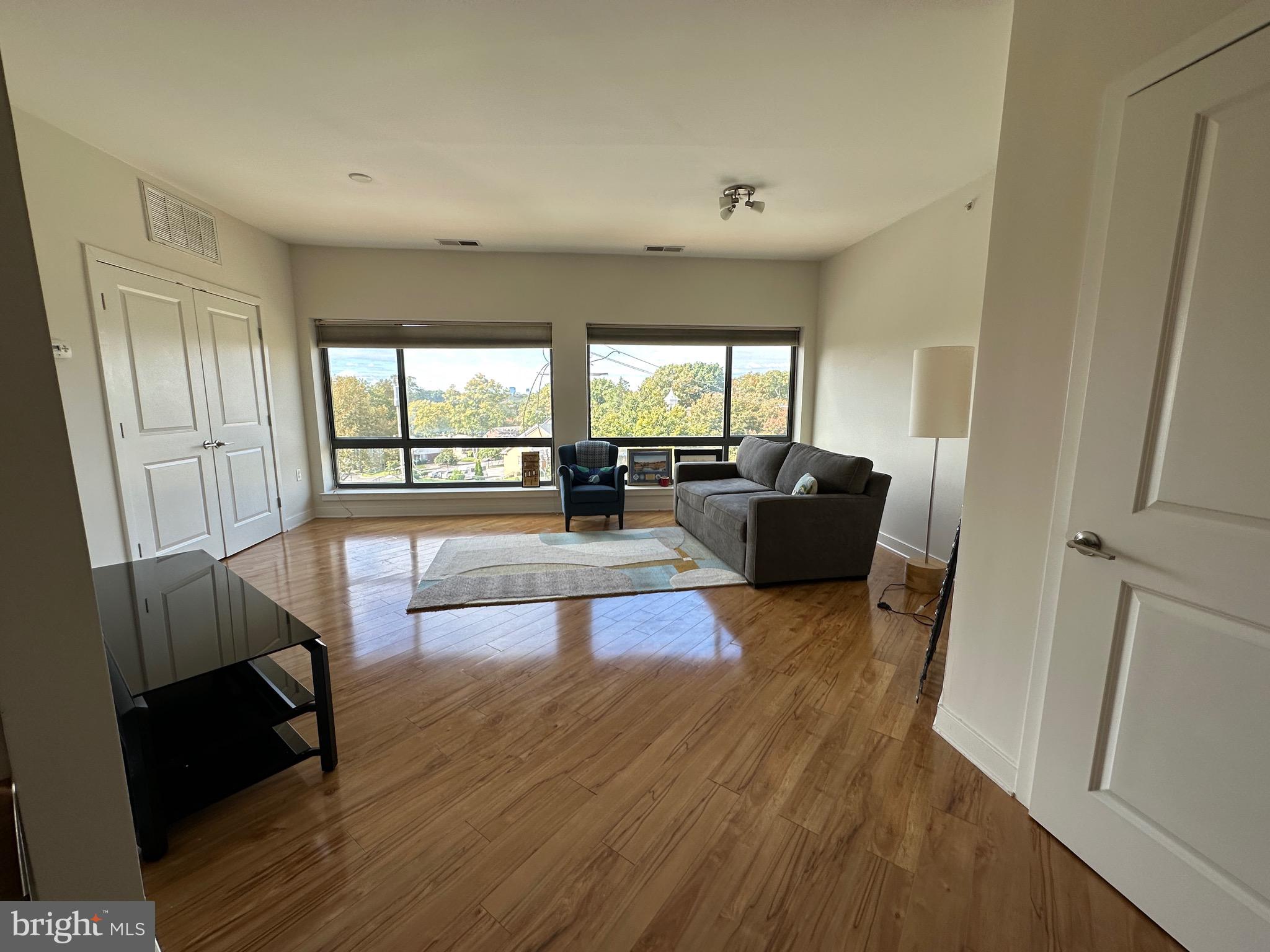 8005 13th Street, Unit 408 Silver Spring, MD 20910 - Photo 5 of 24 a living room with furniture and a large window