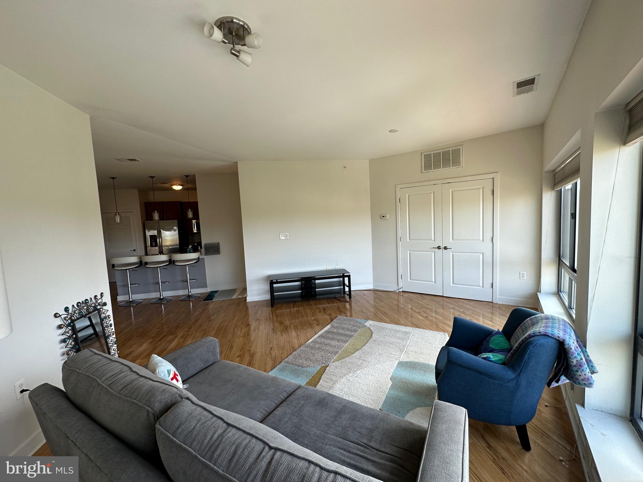 8005 13th Street, Unit 408 Silver Spring, MD 20910 - Photo 6 of 24 a living room with furniture and a wooden floor
