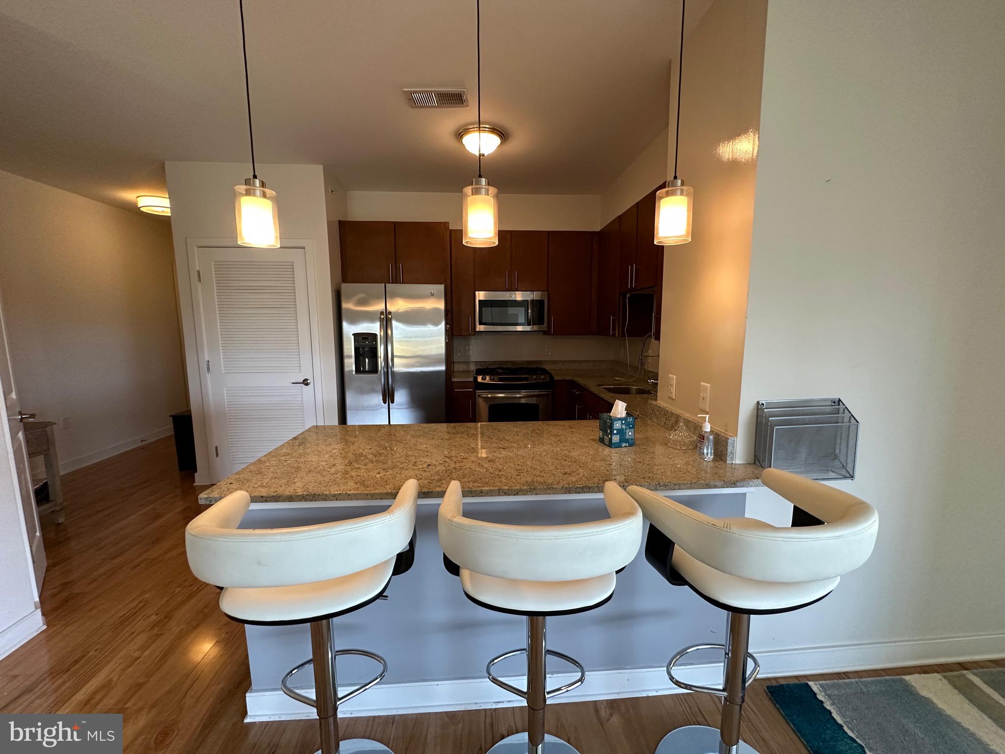 8005 13th Street, Unit 408 Silver Spring, MD 20910 - Photo 7 of 24 a dinning room with furniture and wooden floor