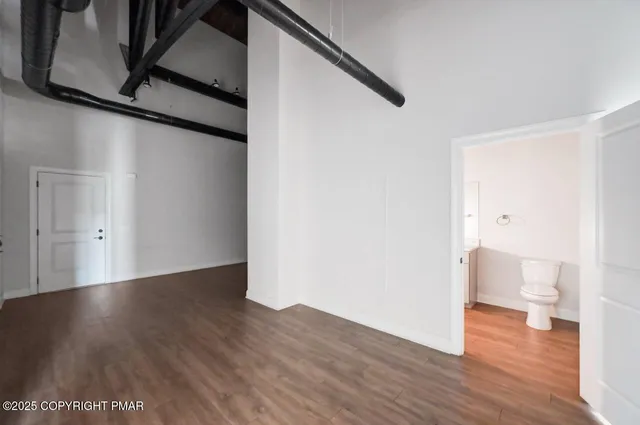 a view of a room with wooden floor and chair