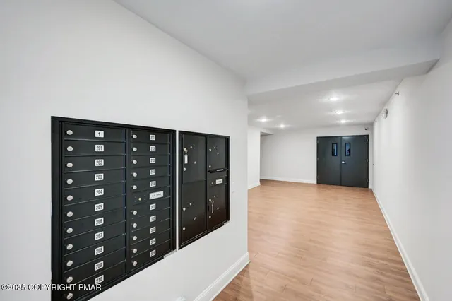 a view of hallway with wooden floor