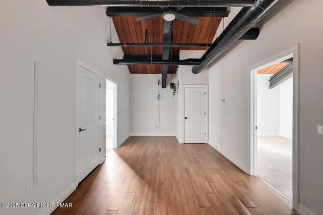 a view of hallway with wooden floor