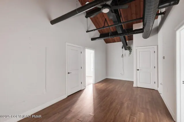 a view of hallway with wooden floor