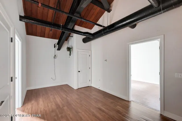 a view of hallway with wooden floor