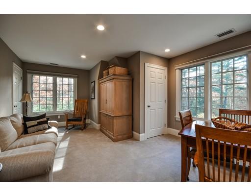 63 Goodnow Road Sudbury, MA 01776 - Photo 23 of 30 a living room with furniture a large window and a flat screen tv