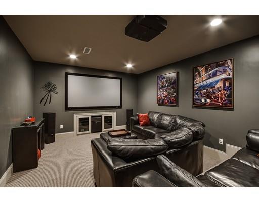 63 Goodnow Road Sudbury, MA 01776 - Photo 25 of 30 a living room with furniture and a flat screen tv