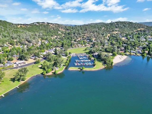 an aerial view of a house with swimming pool and yard