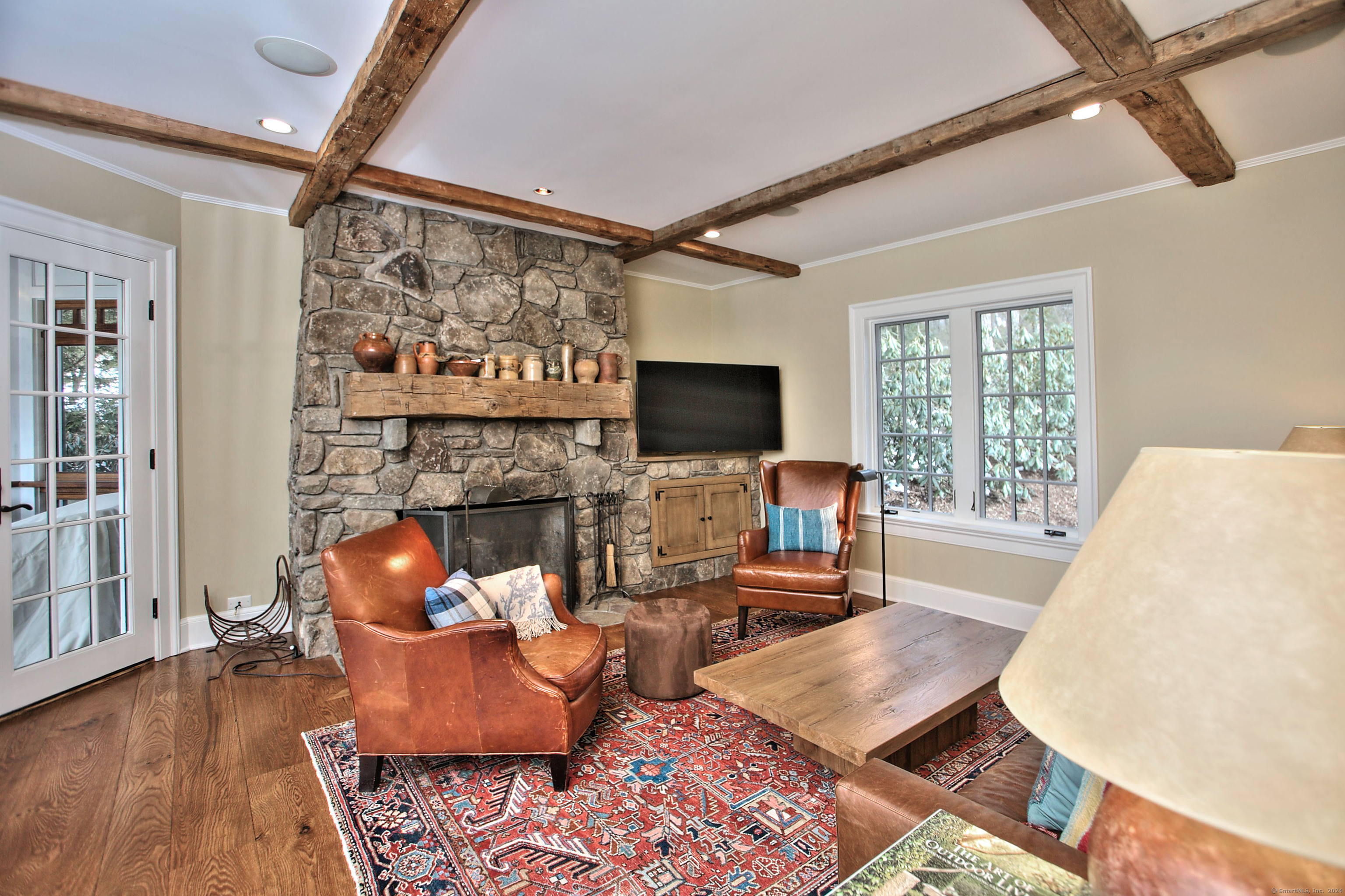 15 Catamount Road Westport, CT 06880 - Photo 12 of 39 a living room with fireplace furniture and a flat screen tv