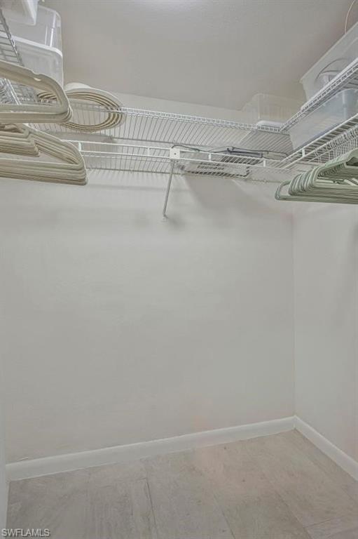 4258 27th Court Southwest, Unit 106 Naples, FL 34116 - Photo 15 of 19 The primary bedroom's walk in closet.