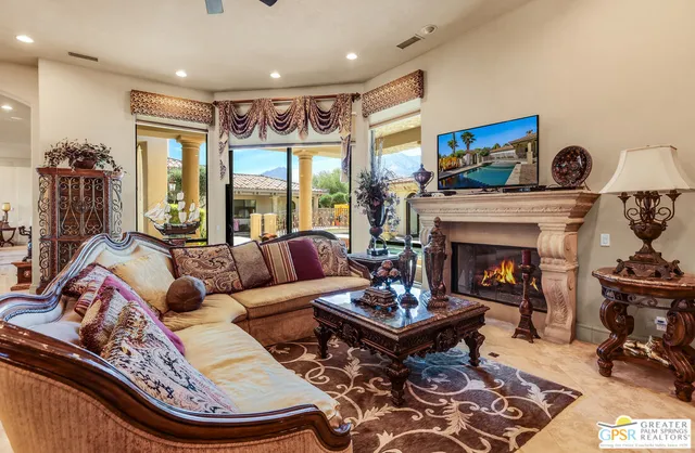 a living room with furniture and a view of kitchen