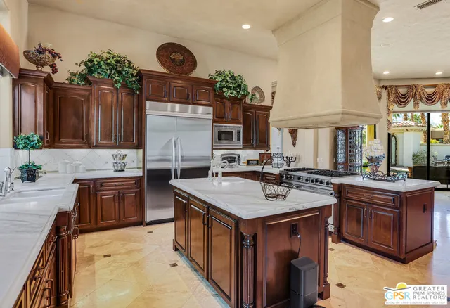 a kitchen with stainless steel appliances granite countertop a stove and a sink