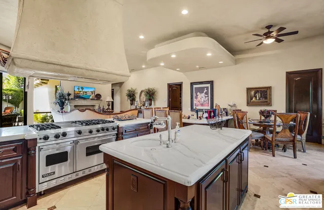 a living room with kitchen island furniture and a potted plant