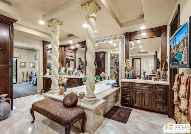 a kitchen with a chandelier and living room
