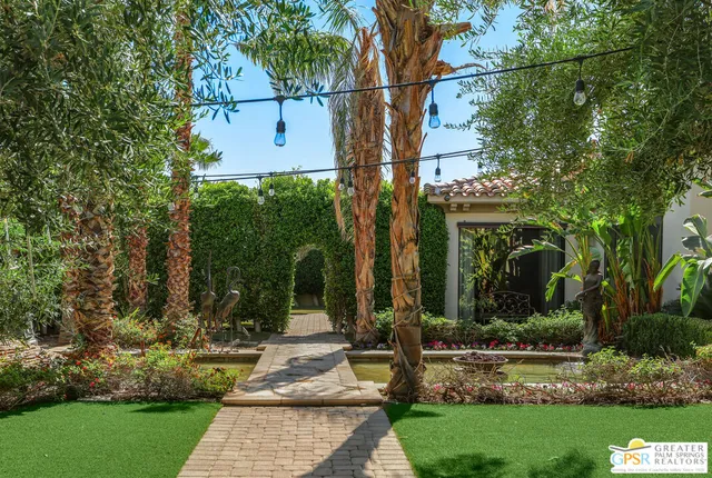 a view of backyard with swimming pool and outdoor seating