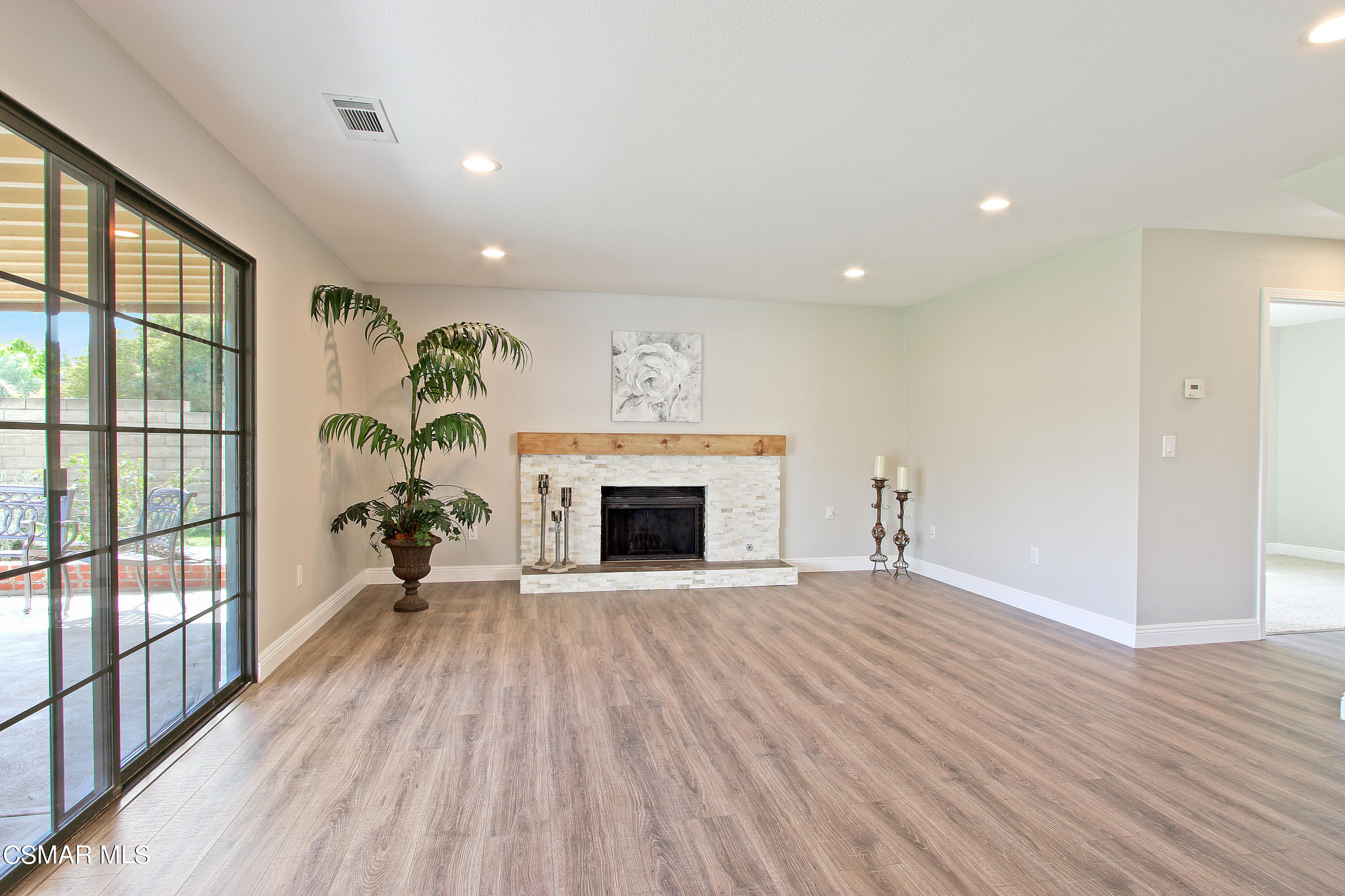 2624 Lemon Drive Simi Valley, CA 93063 - Photo 11 of 22 a view of an empty room with wooden floor fireplace and a window