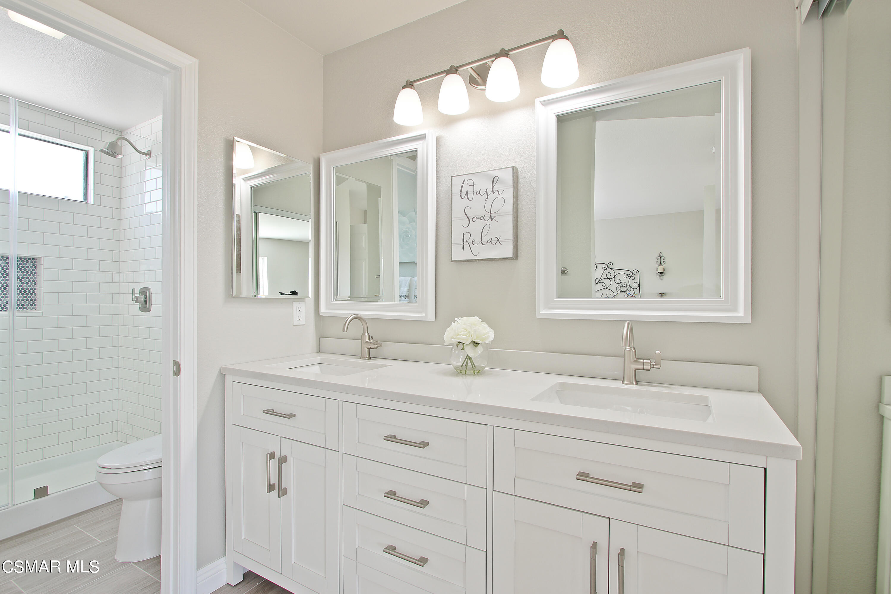 2624 Lemon Drive Simi Valley, CA 93063 - Photo 19 of 22 a bathroom with a double vanity sink mirror and toilet