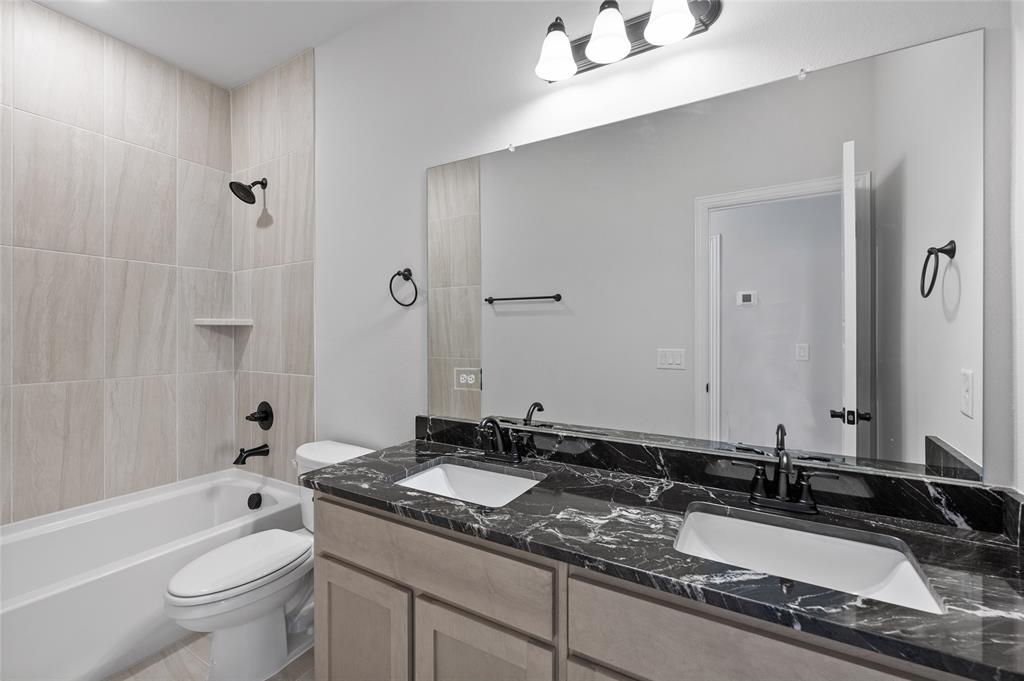 613 Brazos Drive Van Alstyne, TX 75495 - Photo 24 of 29 Bathroom featuring shower / washtub combination and double vanity