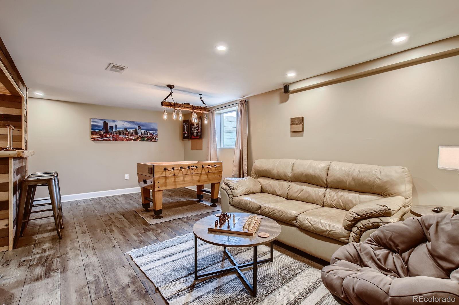 6614 Gray Street Arvada, CO 80003 - Photo 13 of 19 a living room with furniture and a wooden floor