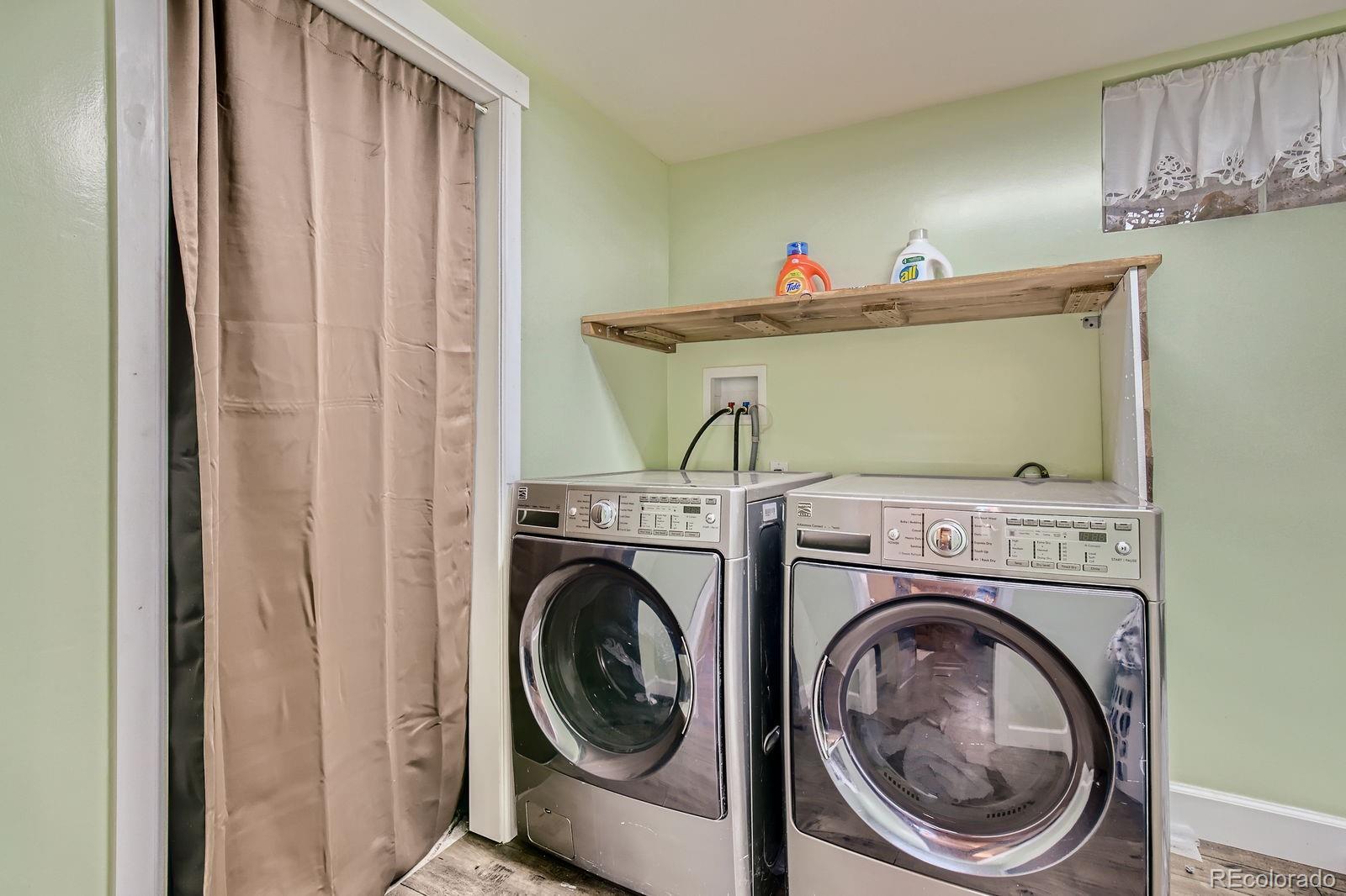 6614 Gray Street Arvada, CO 80003 - Photo 15 of 19 a view of a hallway with washer and dryer