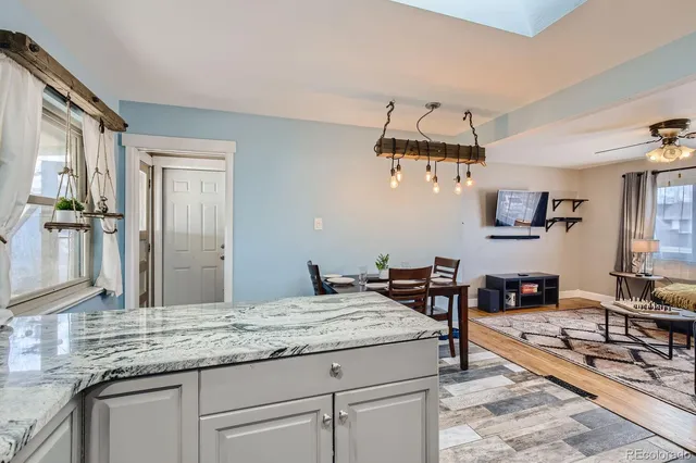 a kitchen with kitchen island granite countertop a table and chairs in it