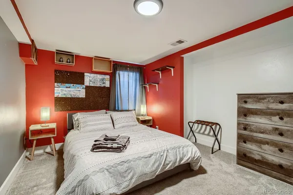 a bedroom with a bed and lamp