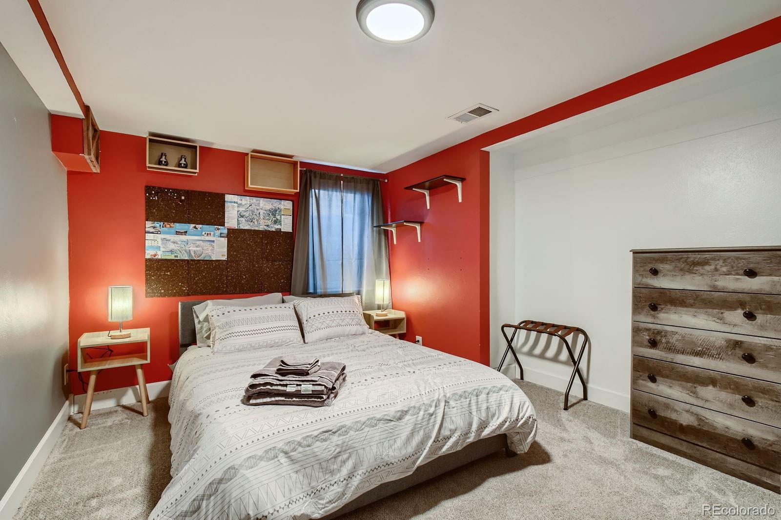 6614 Gray Street Arvada, CO 80003 - Photo 9 of 19 a bedroom with a bed and lamp