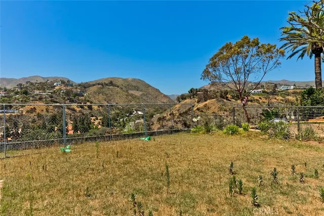 a view of a large building with a mountain in the background