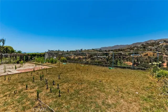 a view of a large mountain with a mountain in the background