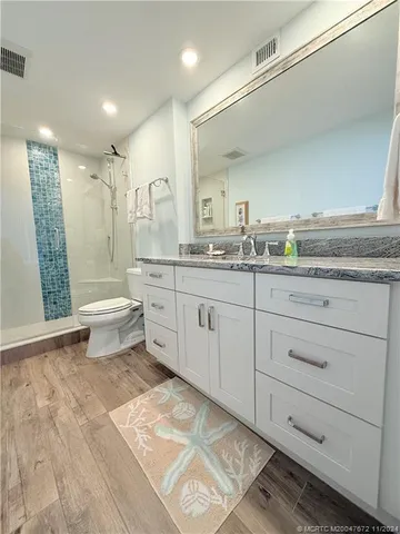 a bathroom with a granite countertop sink mirror and a