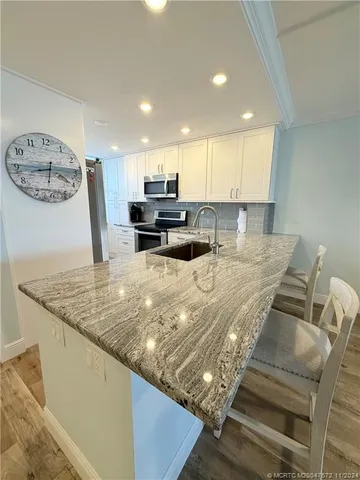 a view of kitchen with cabinets