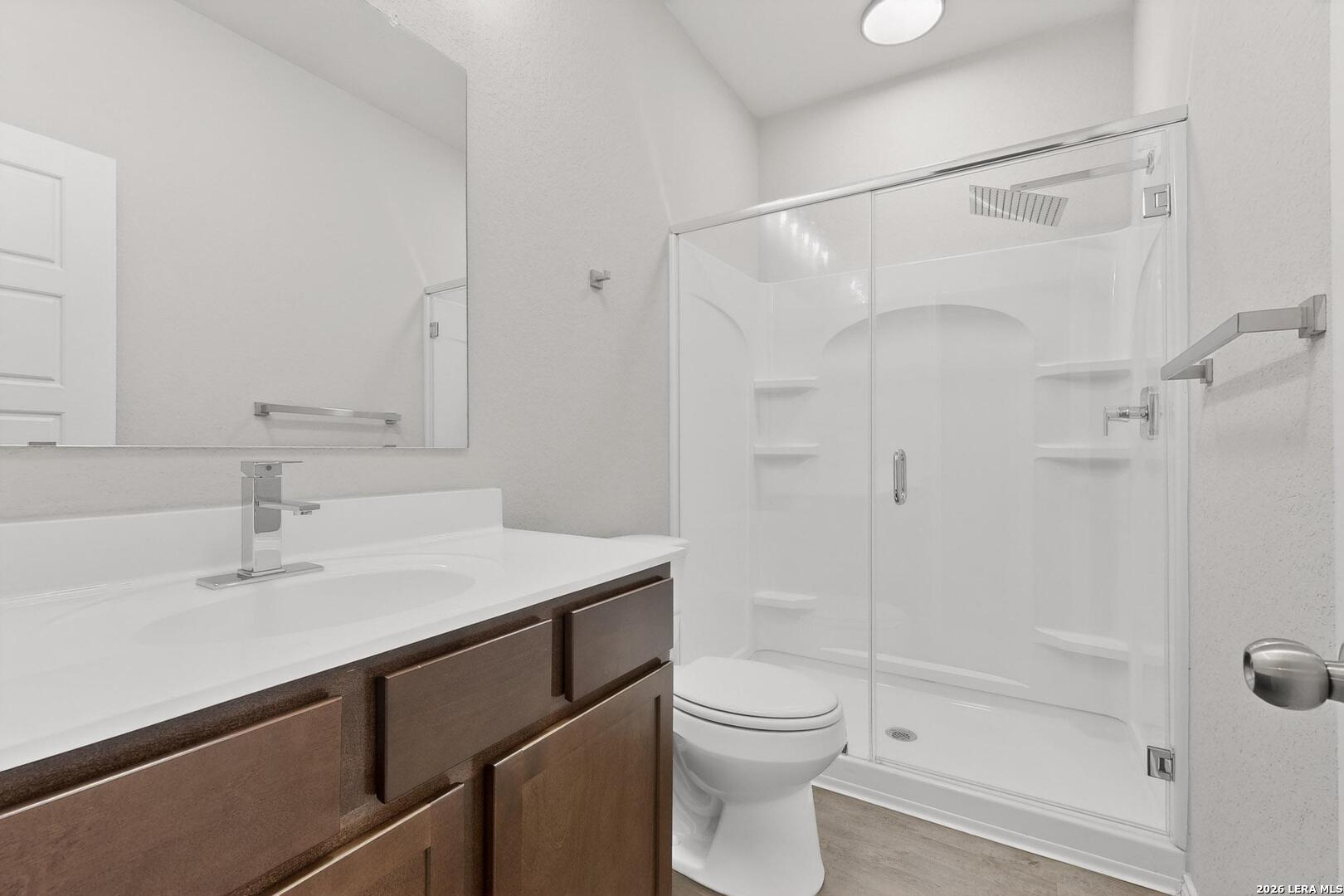 3038 Laguna Cliffs Converse, TX 78109 - Photo 15 of 32 a bathroom with a sink toilet vanity and shower