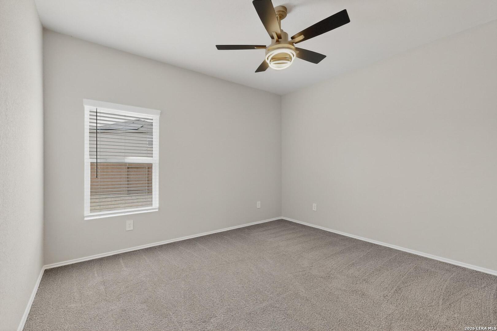 3038 Laguna Cliffs Converse, TX 78109 - Photo 16 of 32 an empty room with a window and a fan