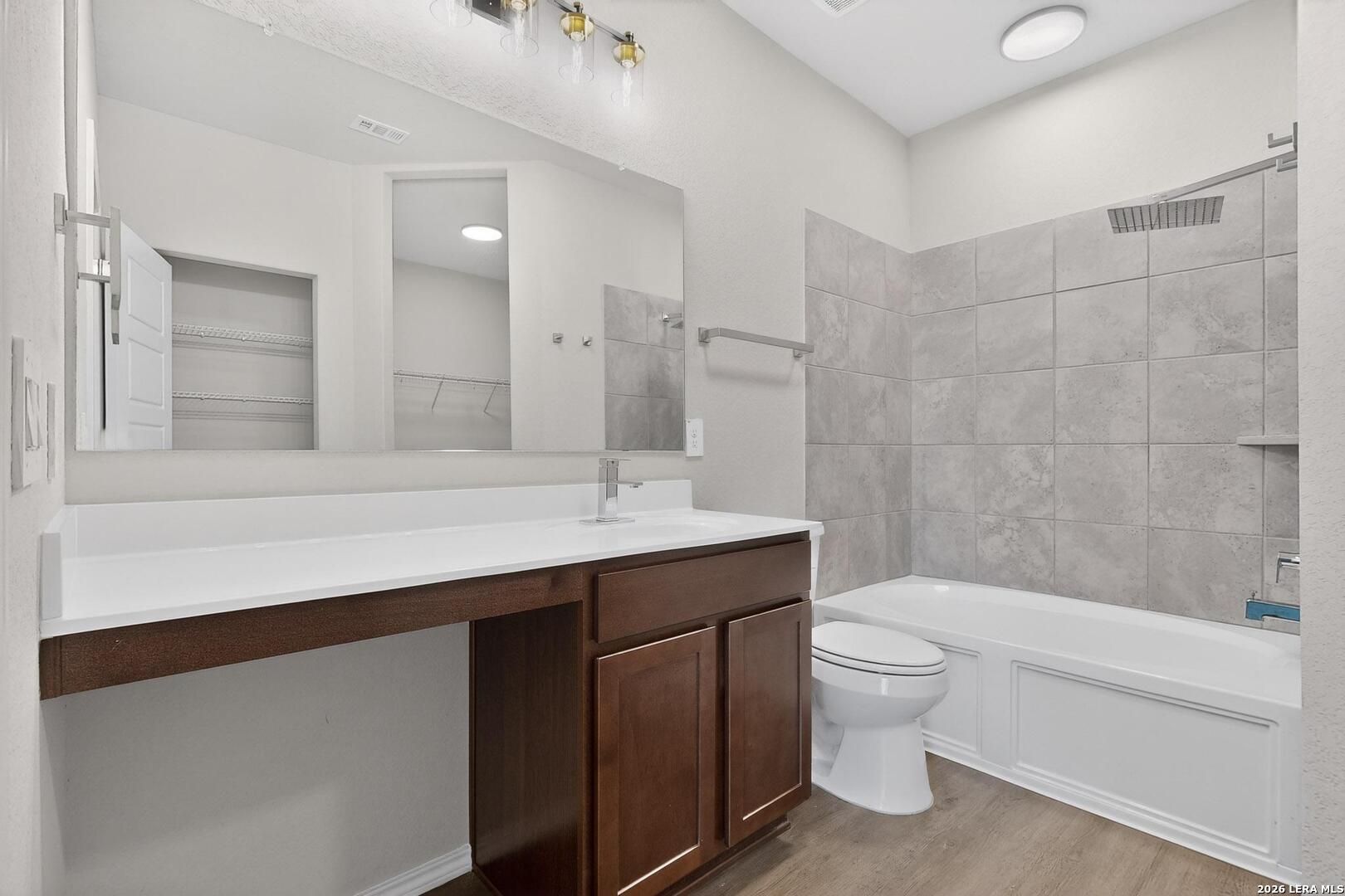 3038 Laguna Cliffs Converse, TX 78109 - Photo 19 of 32 a bathroom with a sink a toilet a mirror and shower