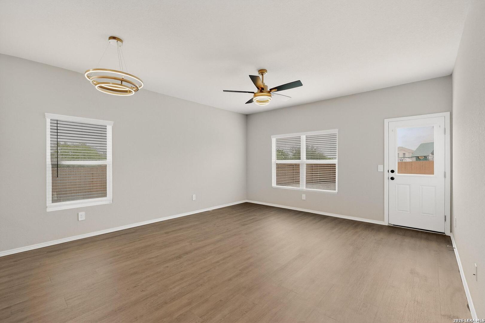 3038 Laguna Cliffs Converse, TX 78109 - Photo 4 of 32 a view of an empty room with a window and wooden floor