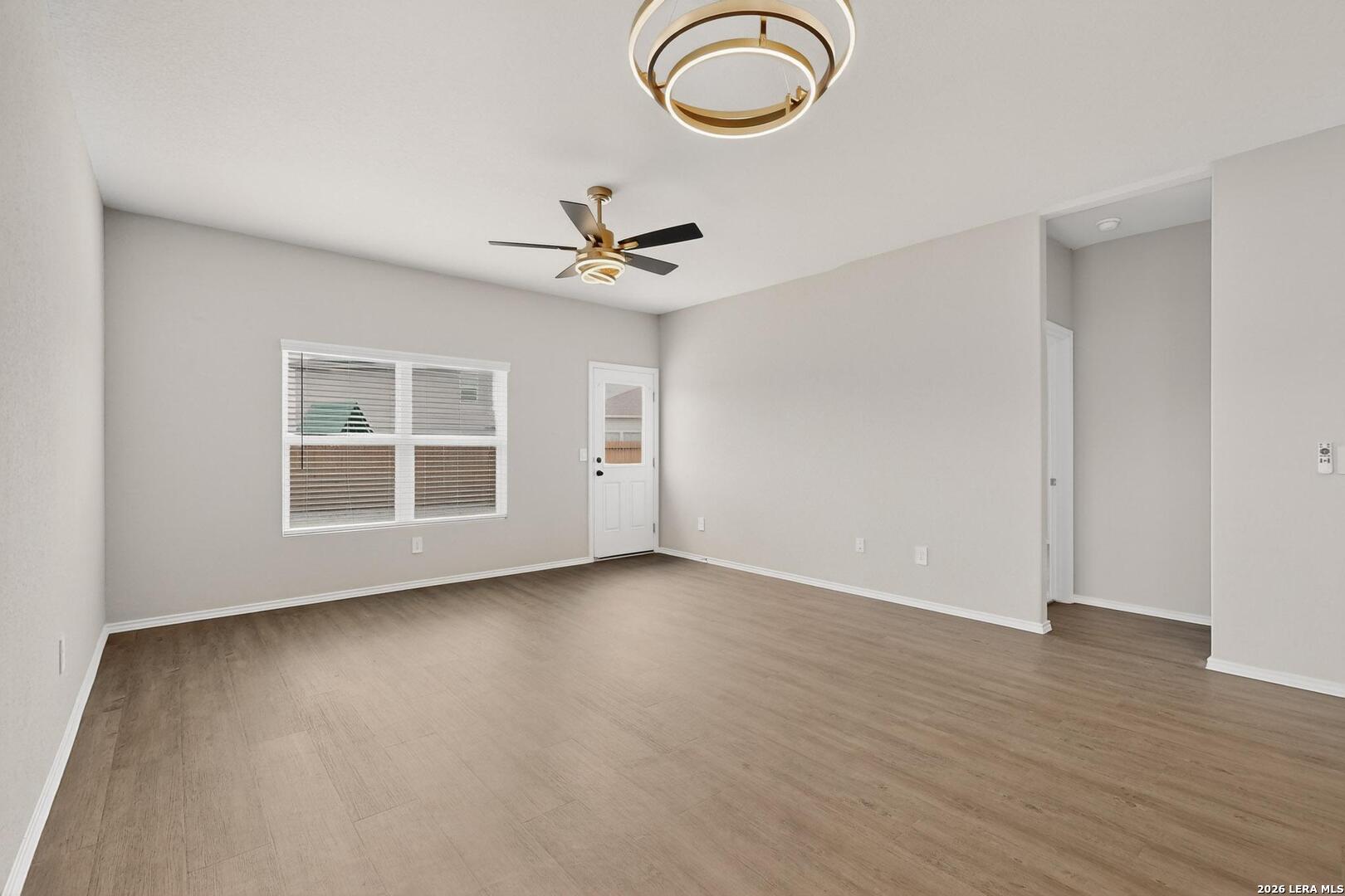 3038 Laguna Cliffs Converse, TX 78109 - Photo 5 of 32 a view of a livingroom with a large window and wooden floor