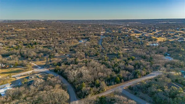 an aerial view of a houses with a yard