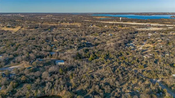 an aerial view of a houses with a lake