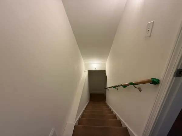 a view of a hallway with a refrigerator