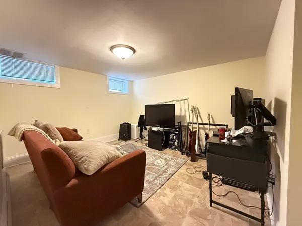a hotel room with furniture a flat screen tv and gym equipment
