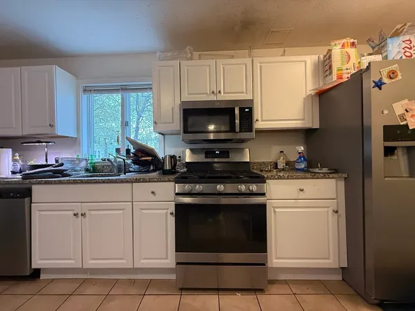 a kitchen with cabinets stainless steel appliances and a sink